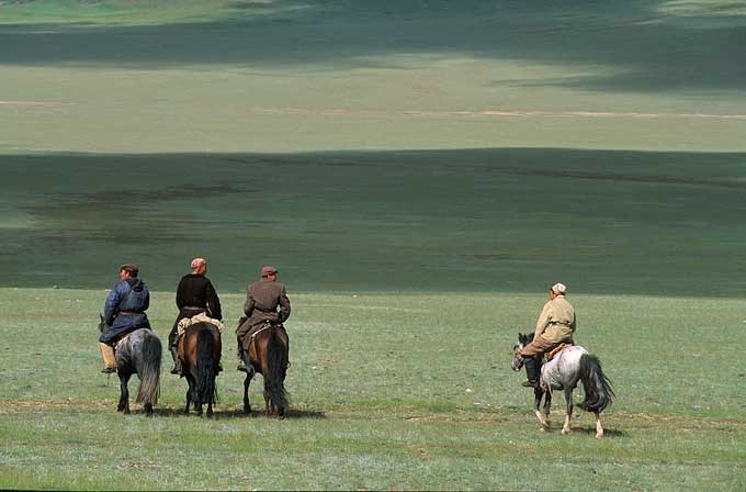 horses-steppe-mongolia nomadic herders on their horses in the vastness of the Mongolian steppes