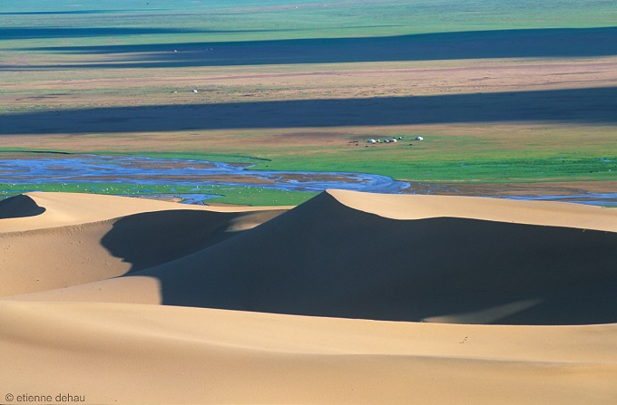 dunes-gobi-steppe yurts in the steppe at the foot of the sand dunes in the Gobi Desert in Mongolia